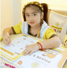 Little Champions Academy Pre-Kindergarten student showing completed Phase 5 workbook