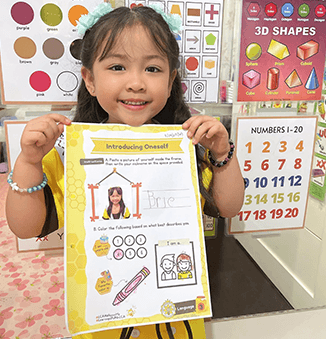 Little Champions Academy Nursery student Brie showing completed 'Introducing Oneself' workbook